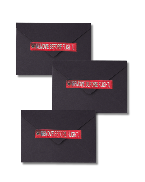 Three Tower Clearance black envelopes, each with a red Remove Before Flight tag